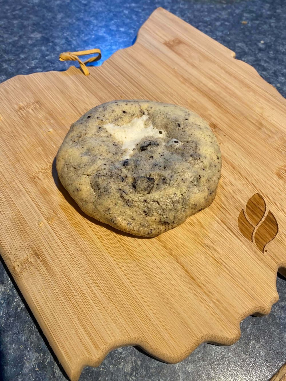 Thick stuffed cookies and cream cookie with crushed Oreos and white cream filling