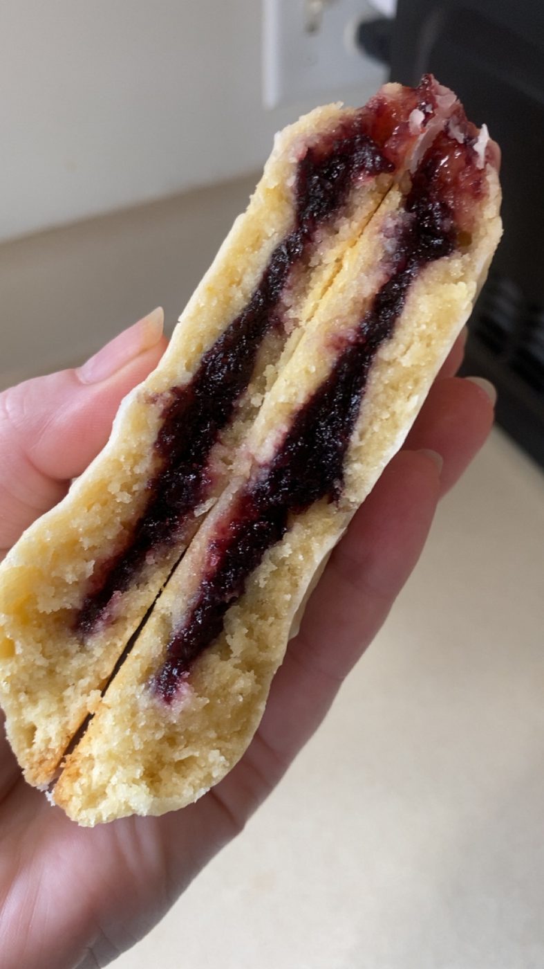 Lemon blueberry cookie split open showing dark berry filling